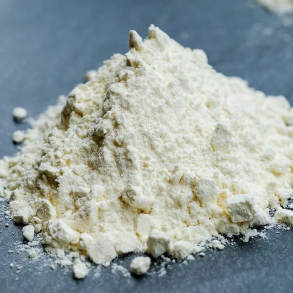 A close-up of a pile of white flour, an essential ingredient for Pizza Collective's pizzas.